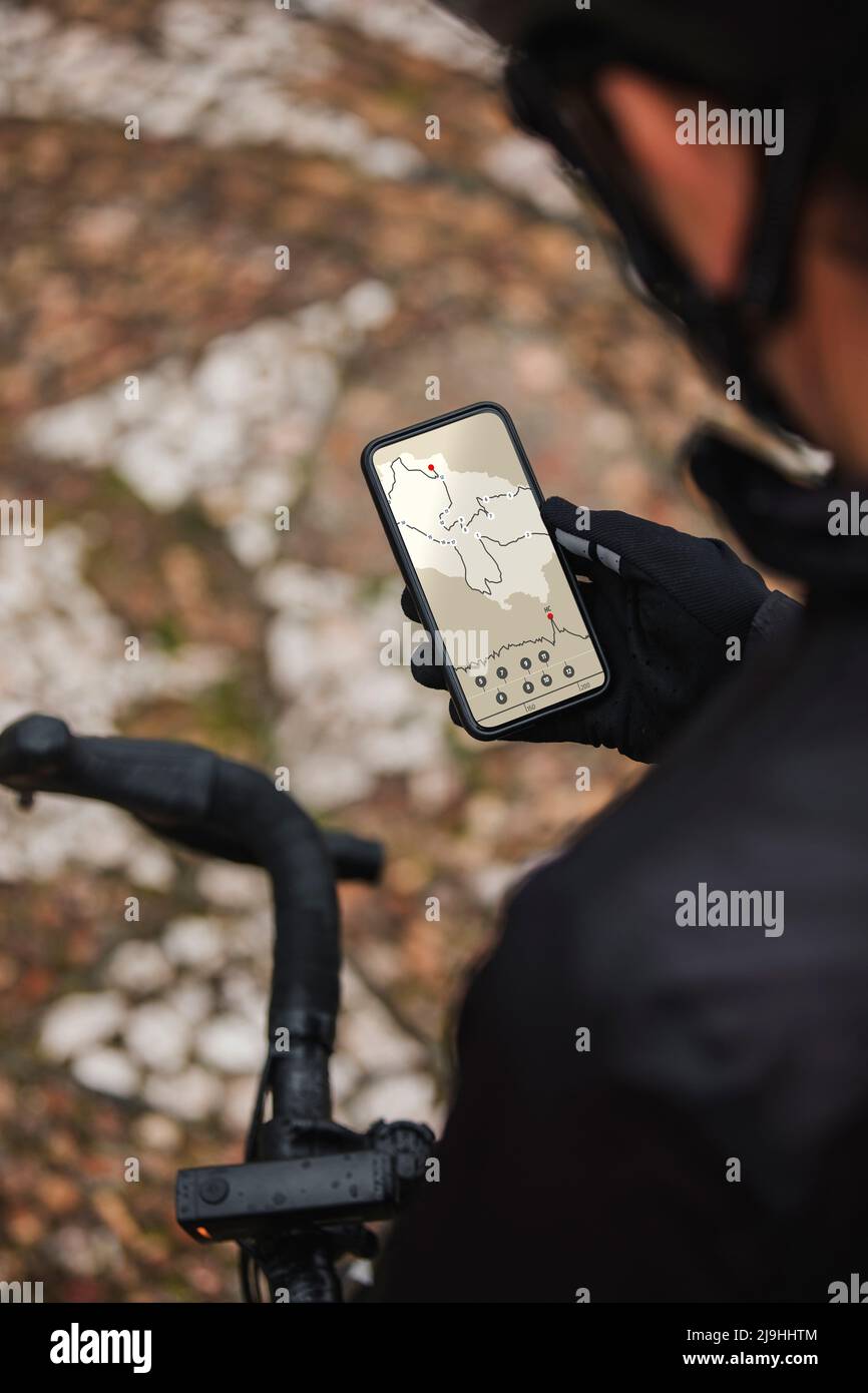 Cyclist checking direction on mobile phone Stock Photo