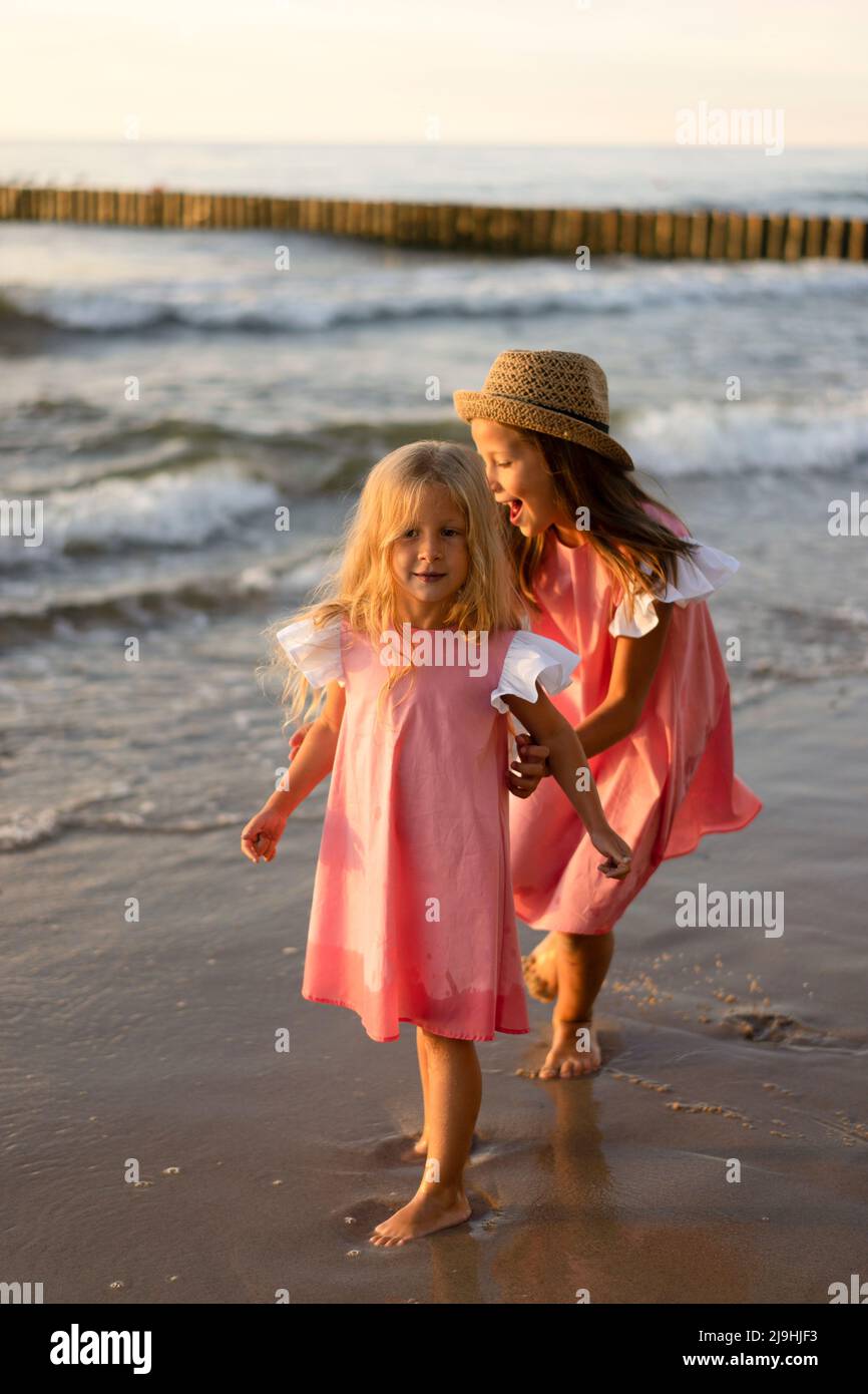 Happy siblings playing together at beach Stock Photo Alamy