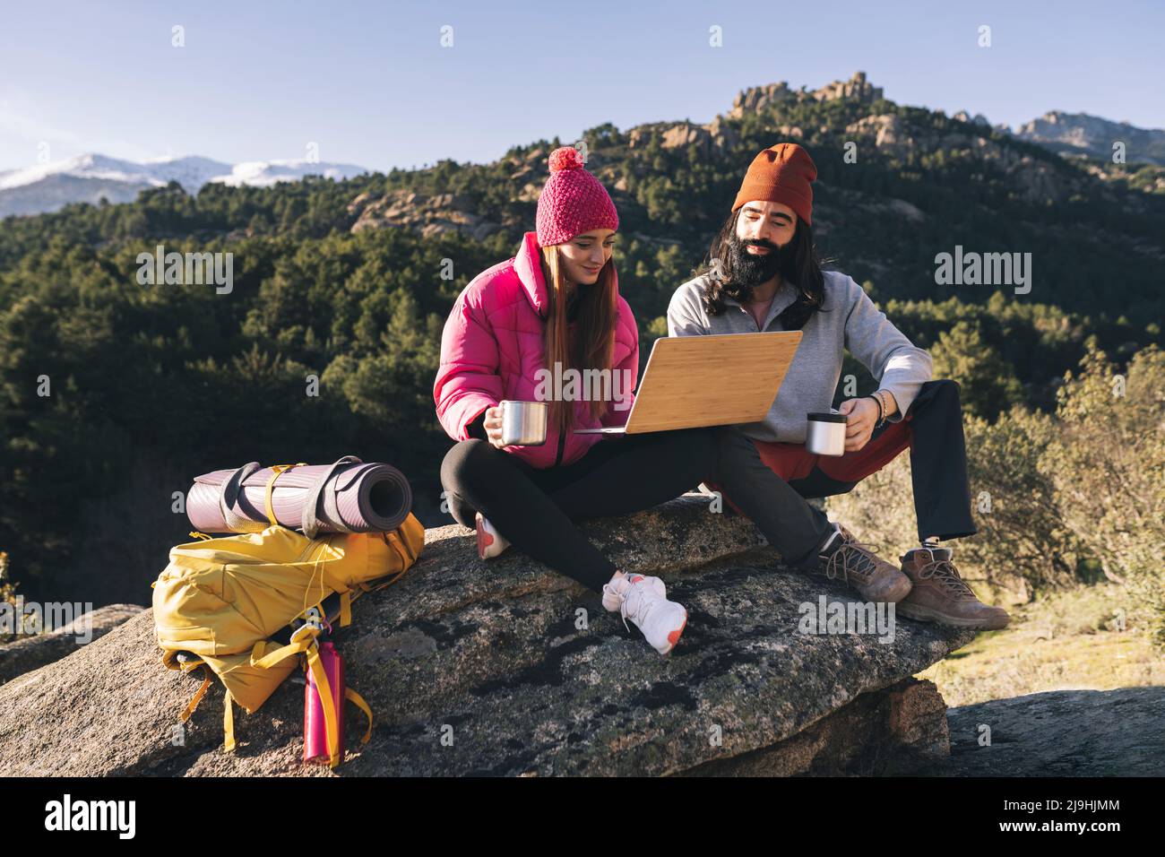 Male and female sitting on rock hi-res stock photography and images - Alamy