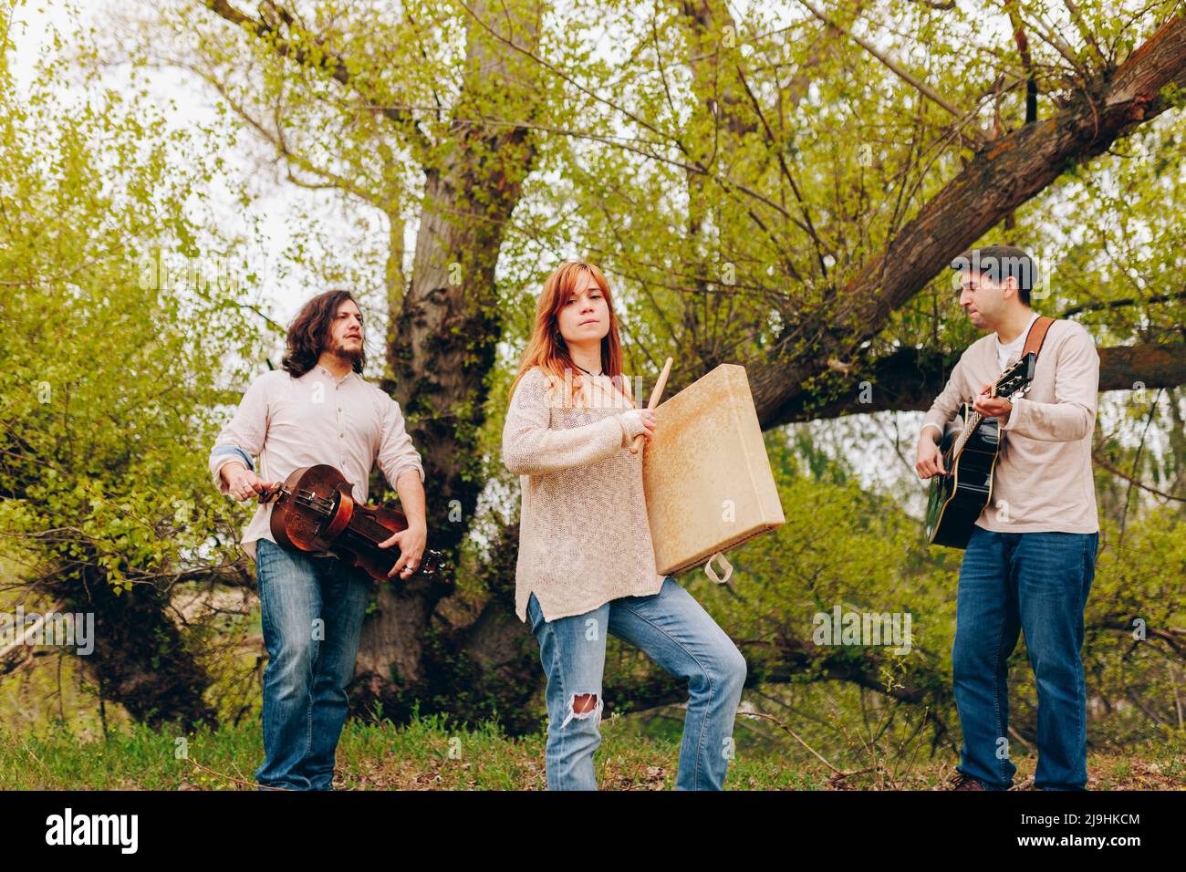 Folk music group doing rehearsal with musical instruments standing in