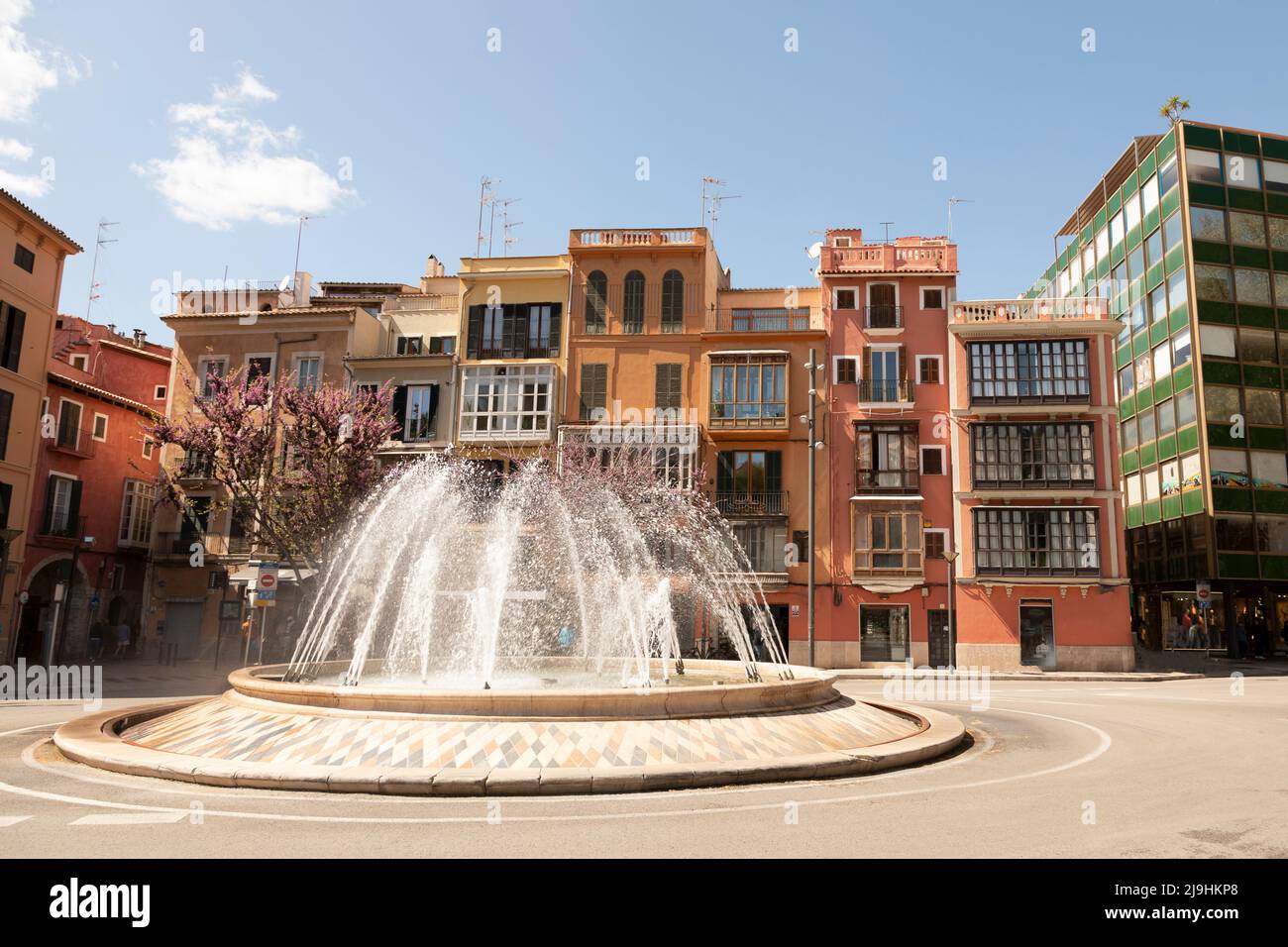 Spain, Balearic Islands, Palma, Traffic circle fountain with row houses in background Stock Photo