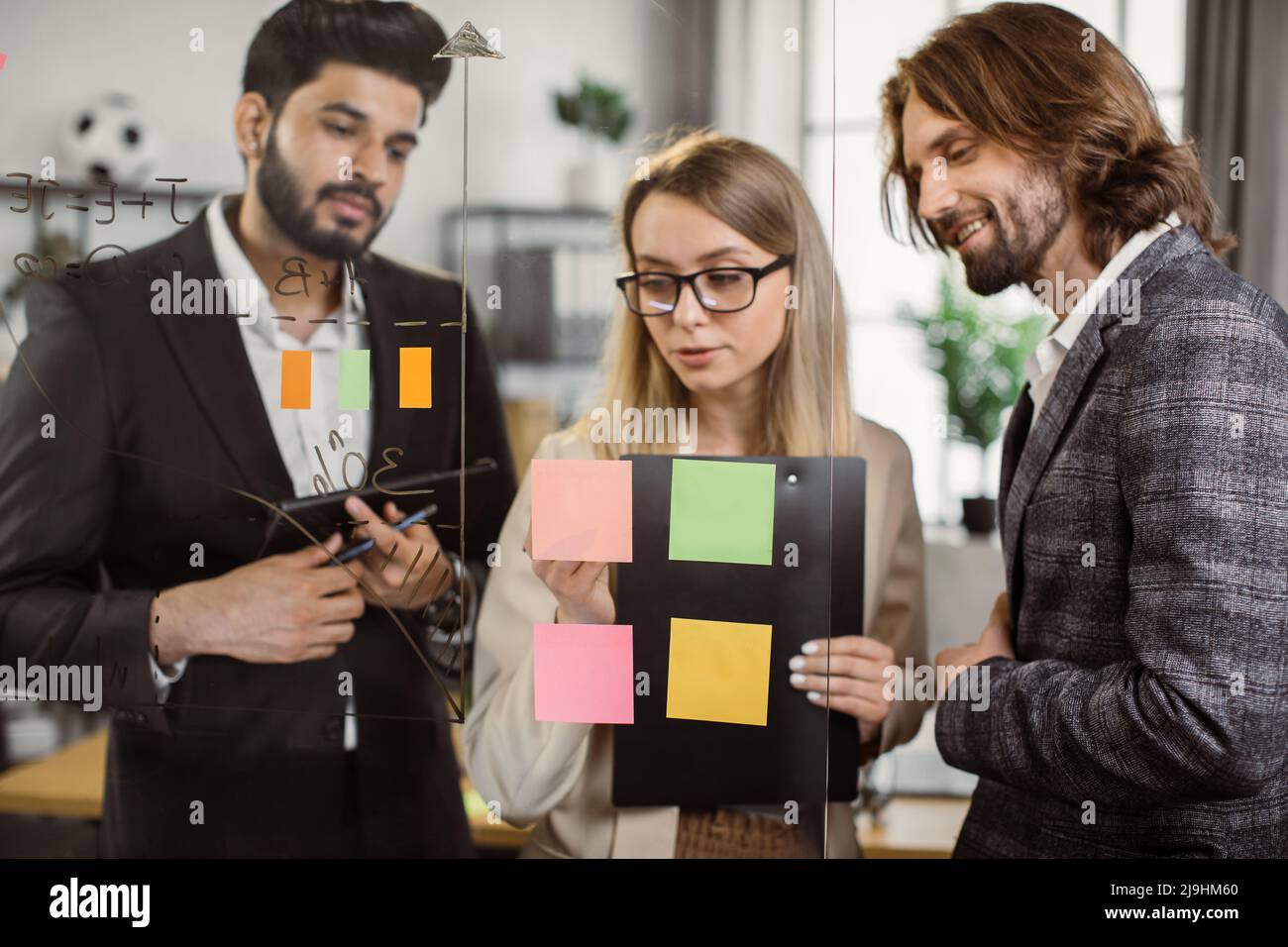 Team of business partners with clipboard and digital tablet in hands ...