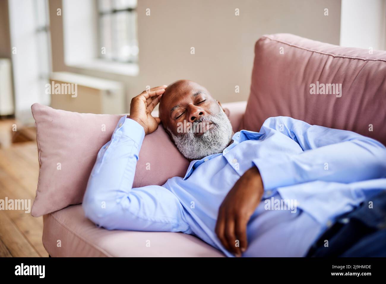 Bald businessman sleeping on sofa at home Stock Photo Alamy