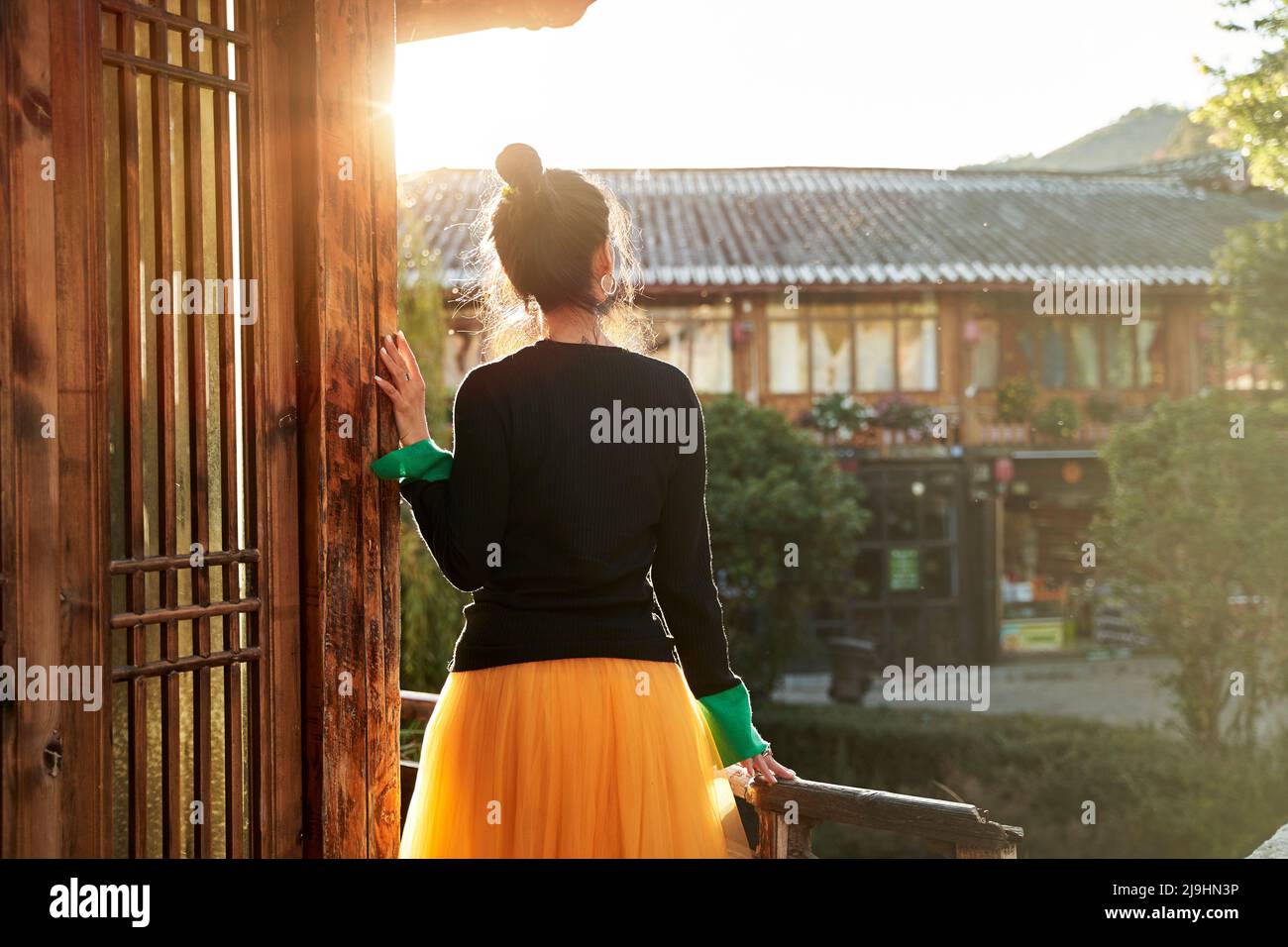 rear view of an asian woman looking at view enjoying sunlight Stock Photo