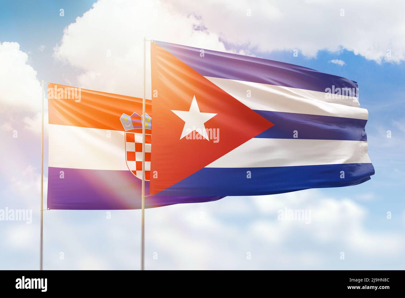 Sunny blue sky and flags of cuba and croatia Stock Photo