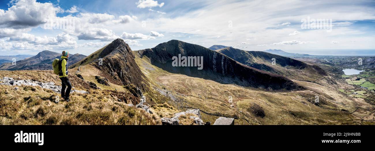 Active woman with backpack standing on mountain ridge Stock Photo - Alamy