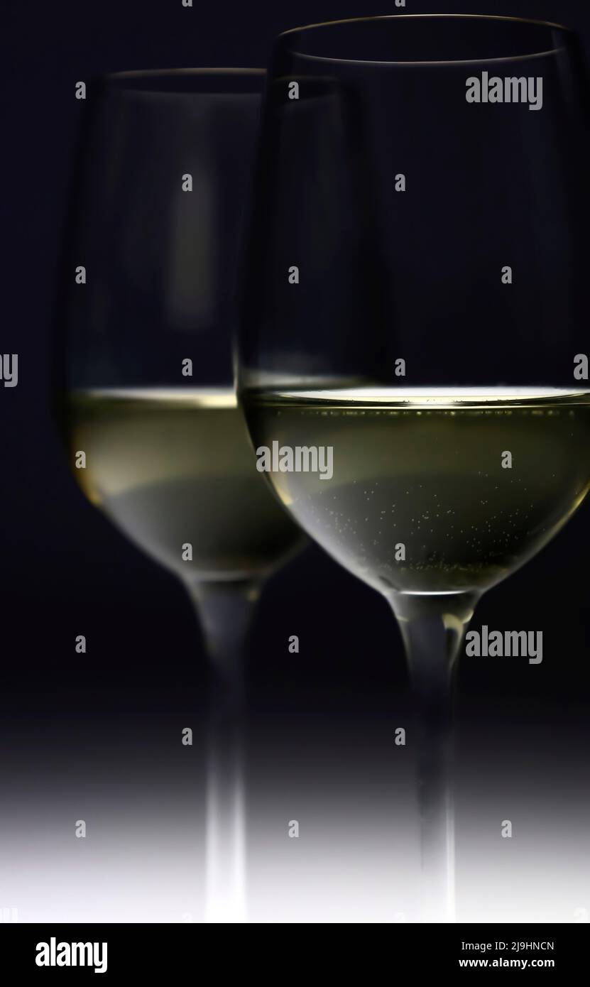 White wine glasses against black background Stock Photo