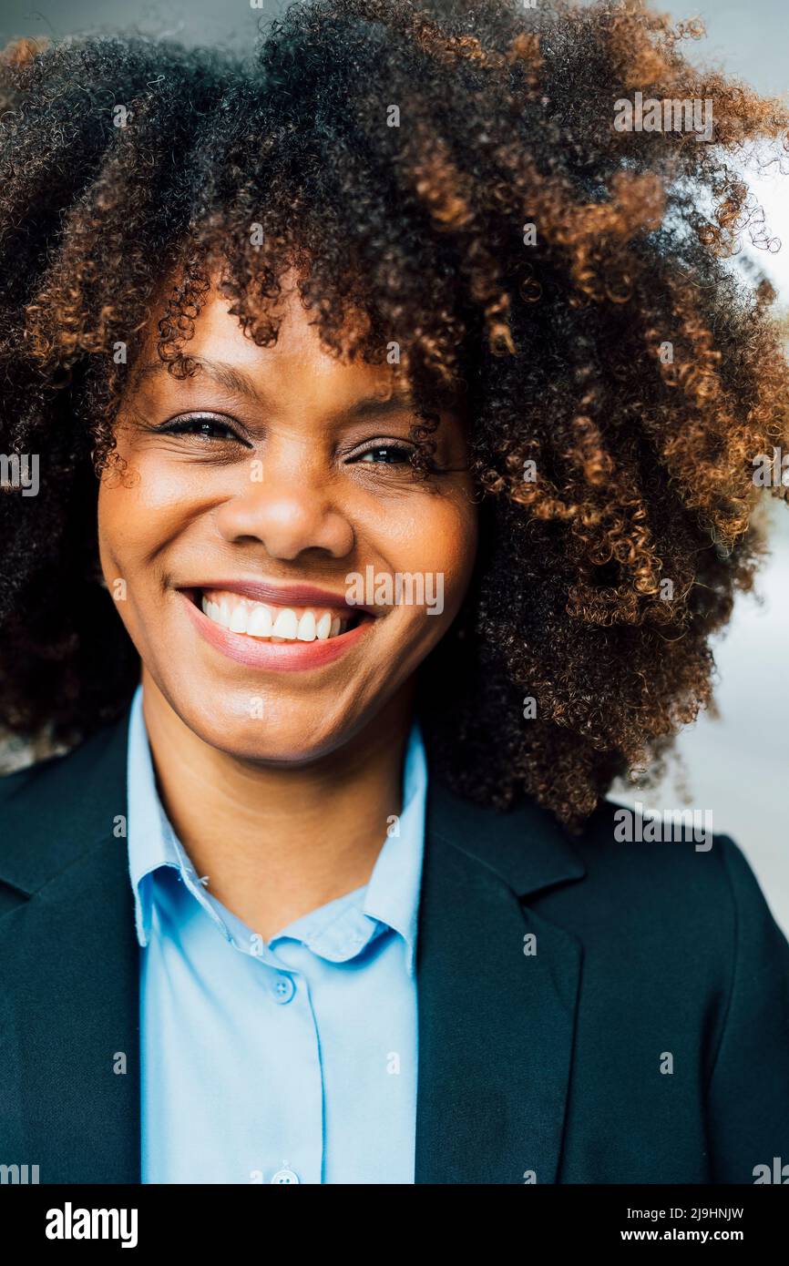 Happy Afro businesswoman wearing suit Stock Photo