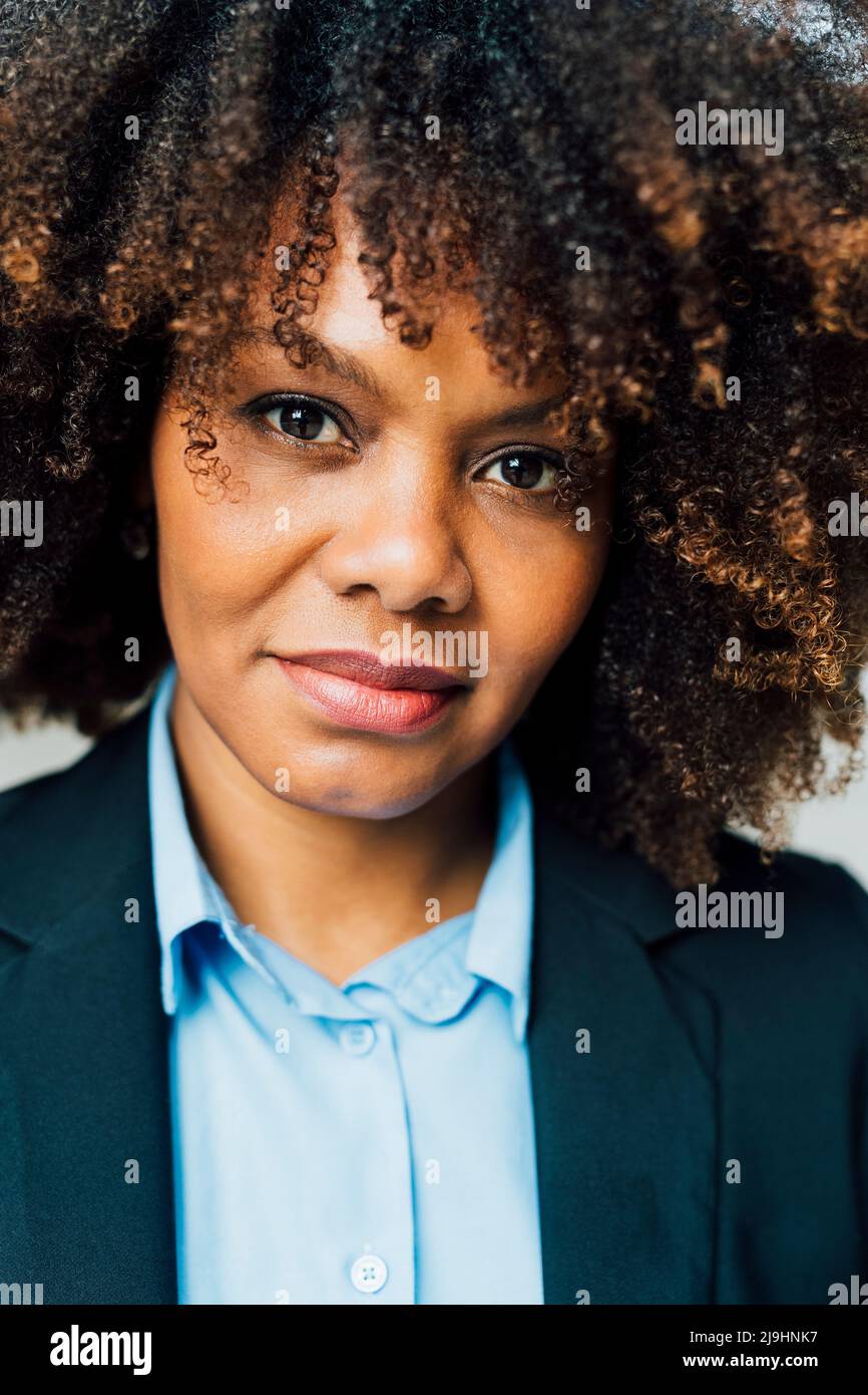 Confident Afro businesswoman wearing suit Stock Photo