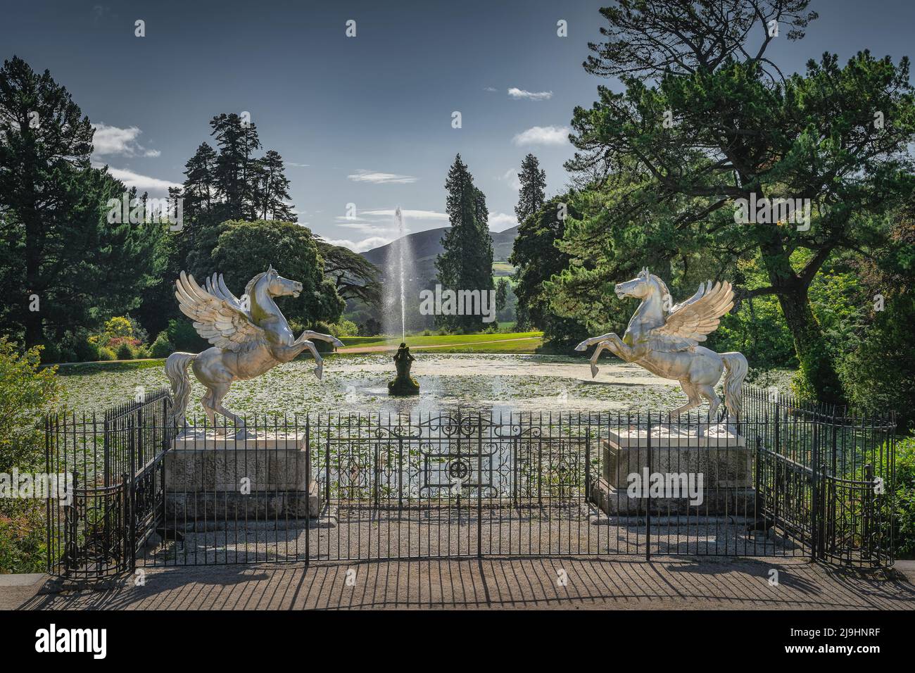 Two pegasus statues and fountain in the pond covered in water lilies
