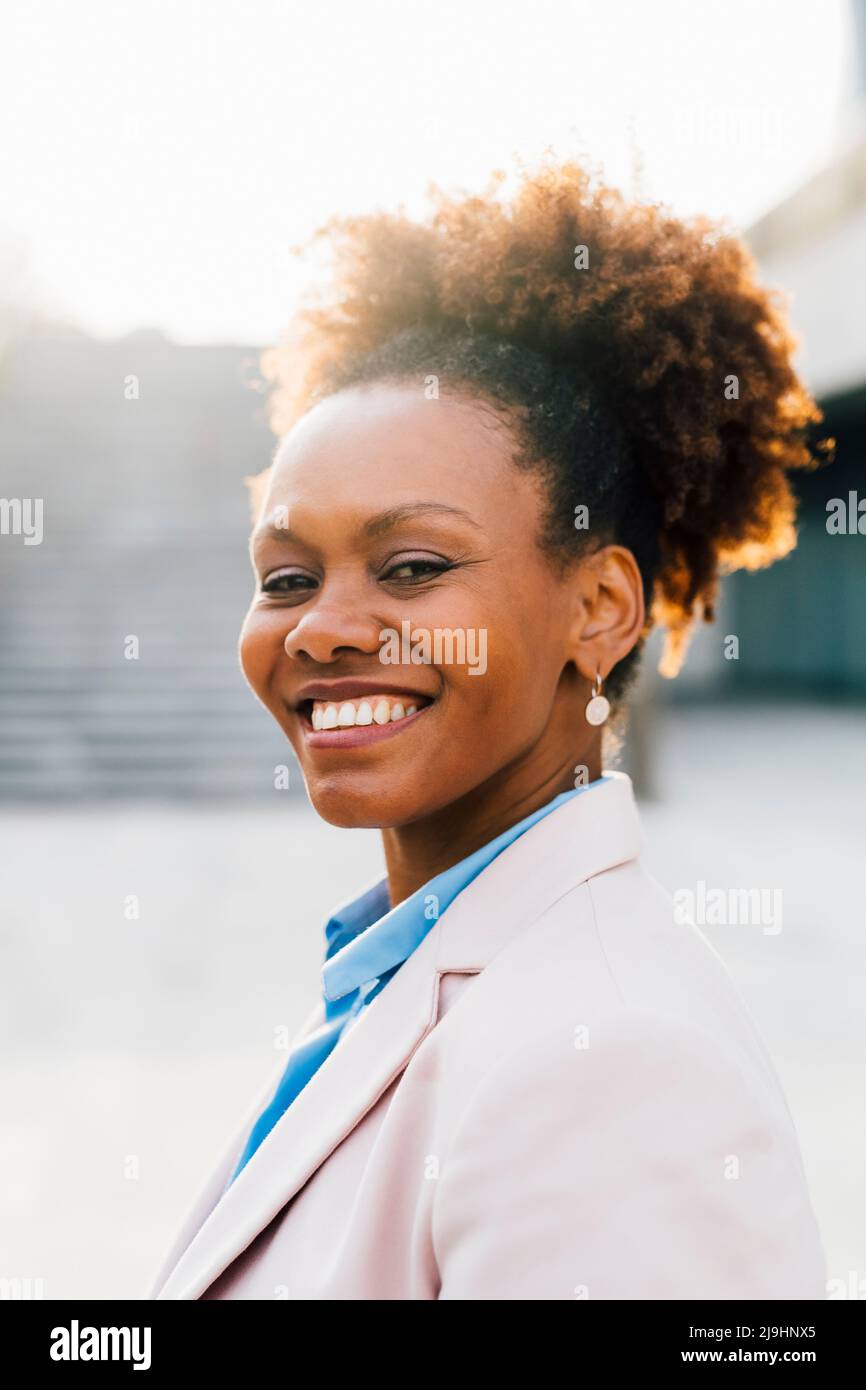Smiling mature businesswoman with Afro hairstyle Stock Photo