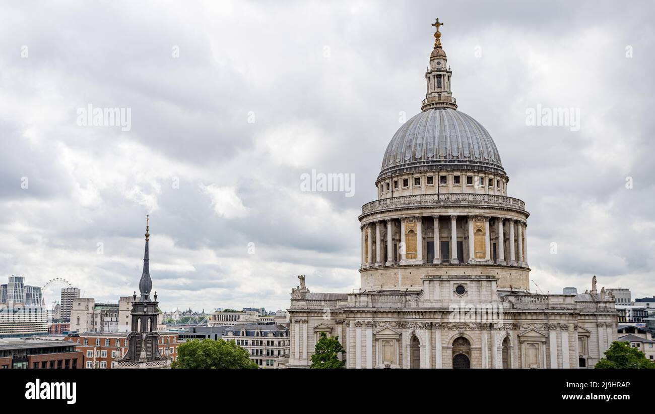 St Pauls Cathedral dome dominating the London skyline seen under grey clouds in May 2022 in Greater London. Stock Photo