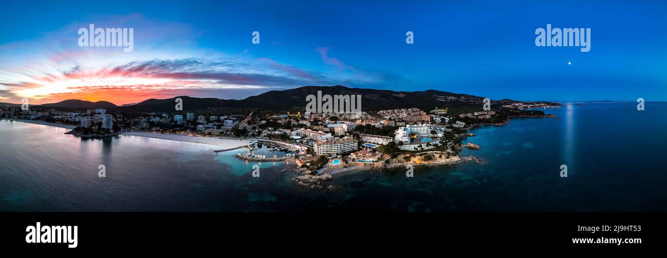 Spain, Balearic Islands, Santa Ponsa, Helicopter panorama of coastal town at dusk Stock Photo