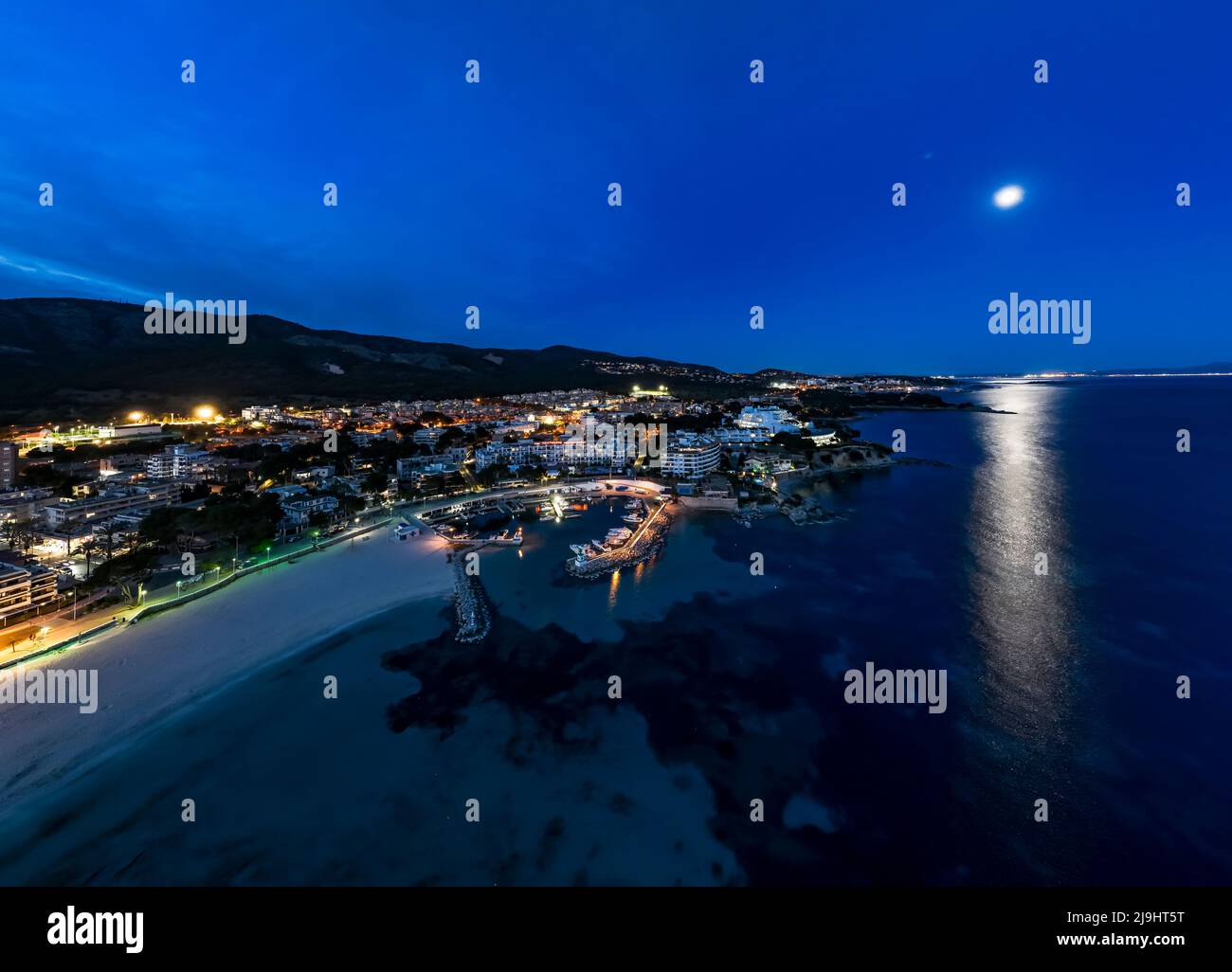 Spain, Balearic Islands, Santa Ponsa, Helicopter view of coastal town at night Stock Photo