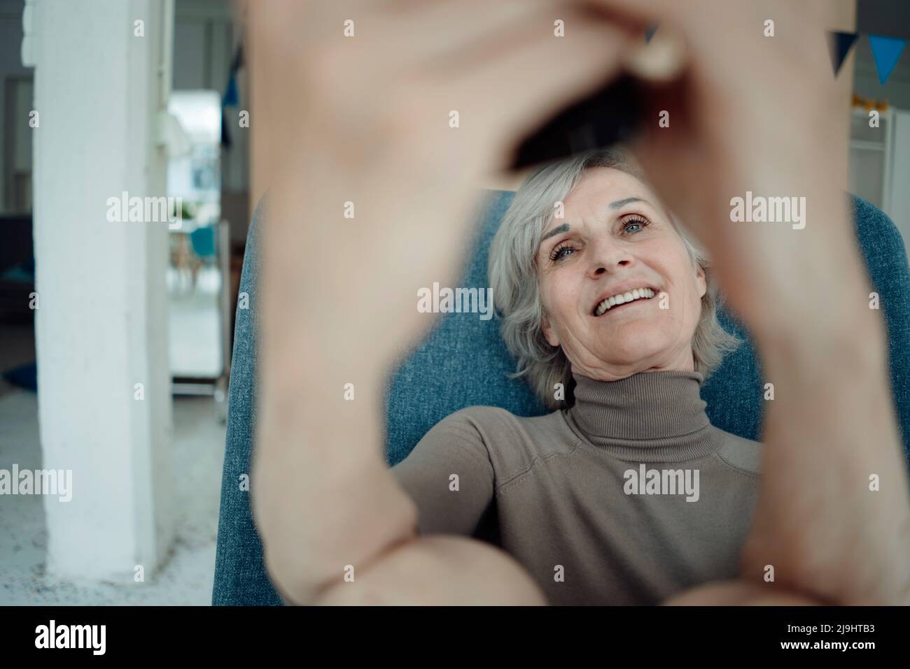 Senior woman sitting chair hi-res stock photography and images - Alamy