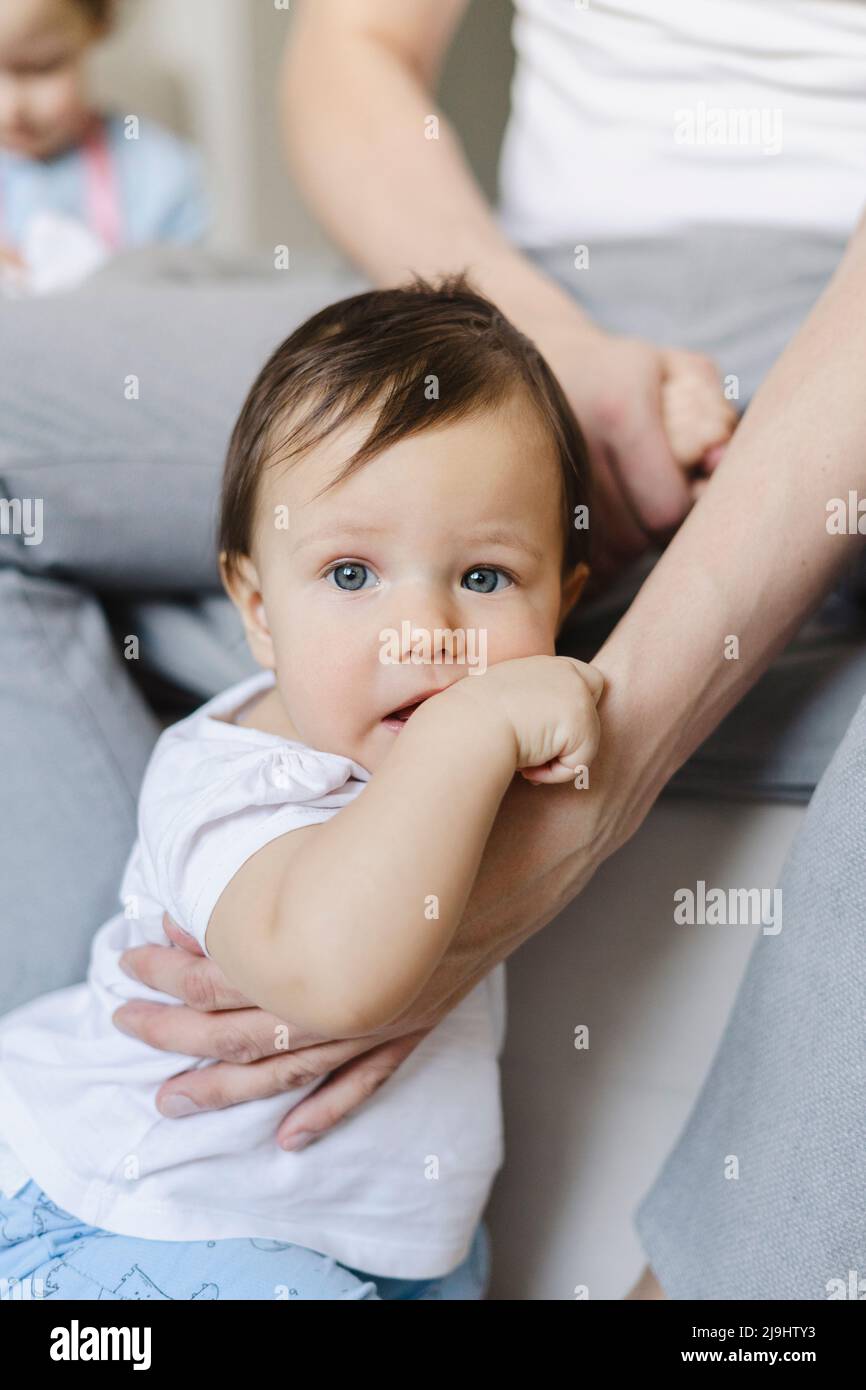 Cute baby boy with father at home Stock Photo Alamy
