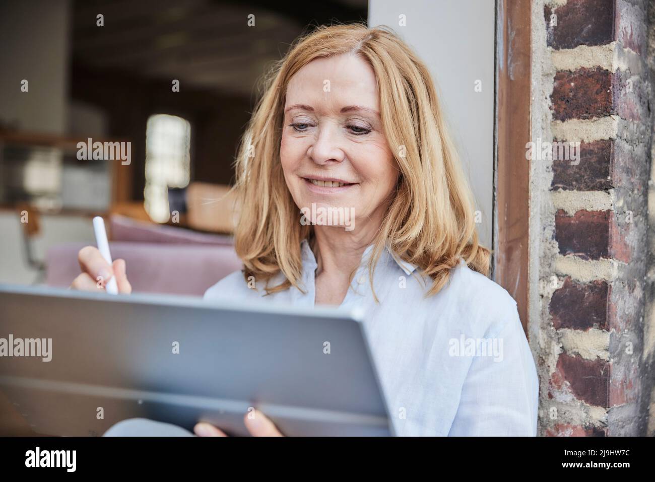Smiling businesswoman using tablet PC Stock Photo