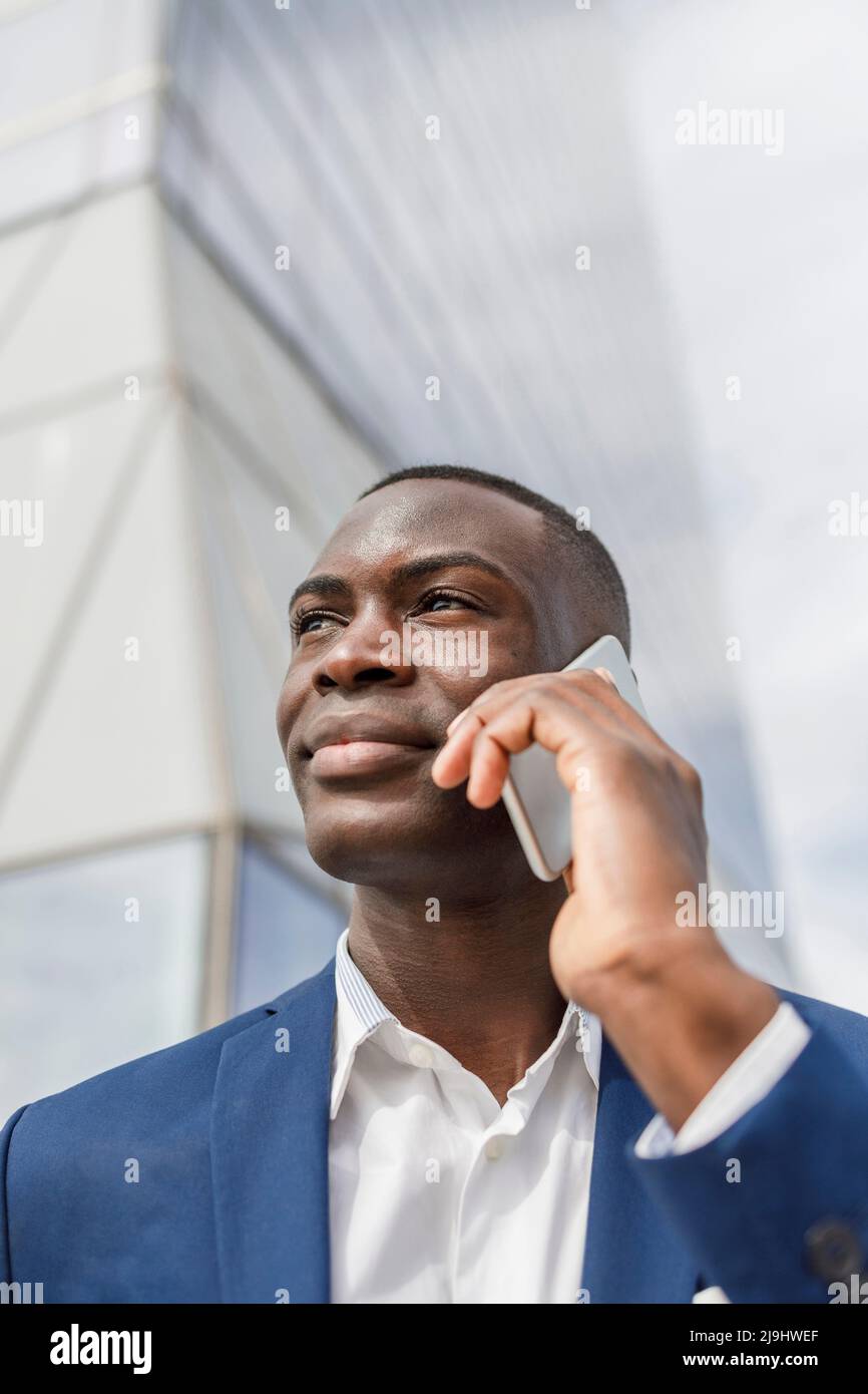Smiling businessman talking on mobile phone Stock Photo