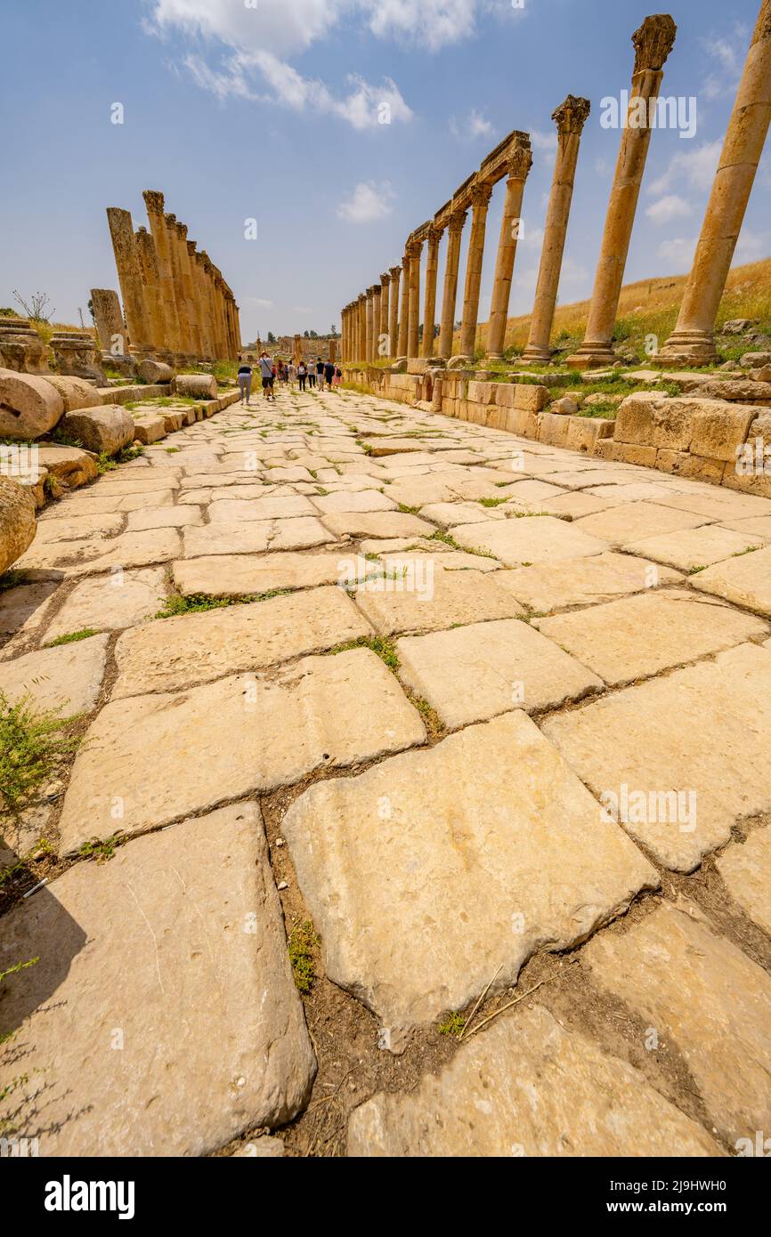 The view along Cardo Maximus in the roman ruins of Jerashs showing the worn ruts from roman chariots. Stock Photo