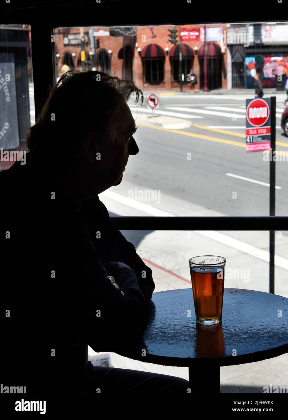 A man enjoys a beer at the Vesuvio Cafe, a landmark American bar in the North Beach section of San Francisco, California. Stock Photo