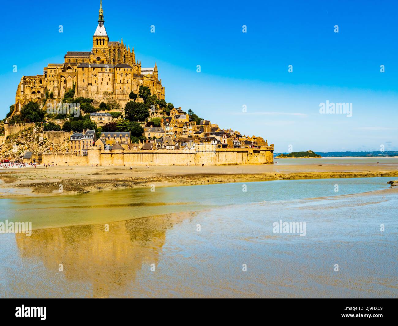 Le Mont Saint Michel, impressive view of the famous abbey during low tide on a bright sunny day, Normandy, Northern France Stock Photo