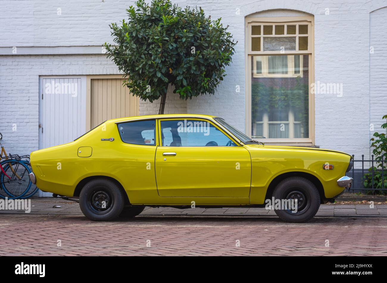 Breda, North Brabant, The Netherlands, 19.05.2022, Side view of vintage car Datsun 120 Y Deluxe  from year 1976 Stock Photo