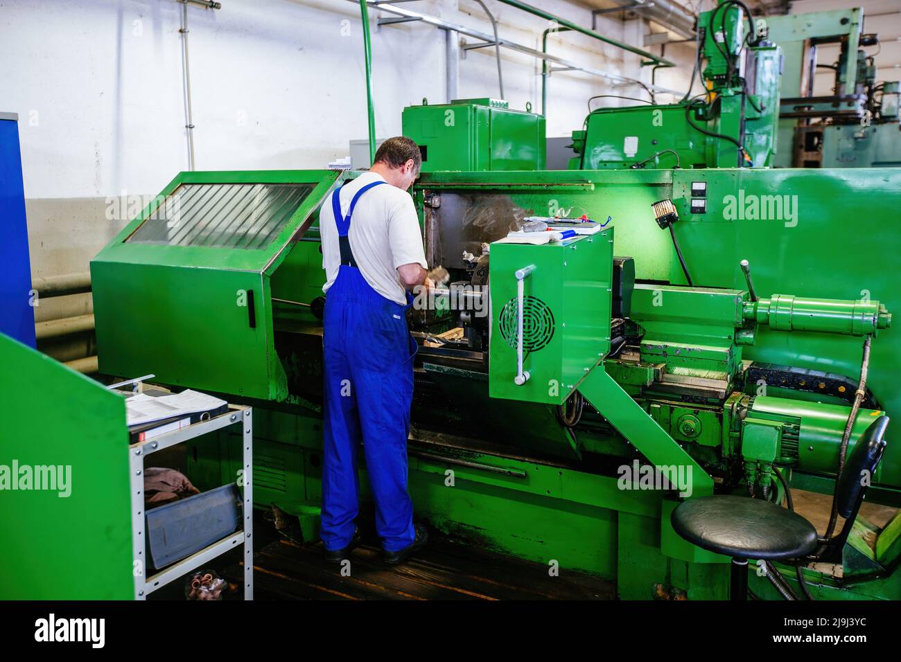 Factory worker working on the lathe Stock Photo Alamy