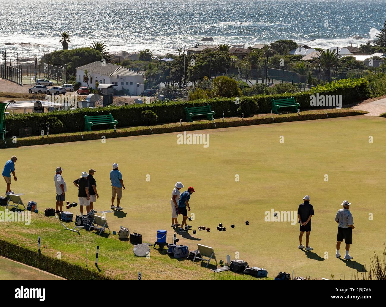 Camps Bay, Cape Town, South Africa. 2022. Adults playing bowls overlooking the sea at Camps Bay close to Cape Town, South Africa. Stock Photo