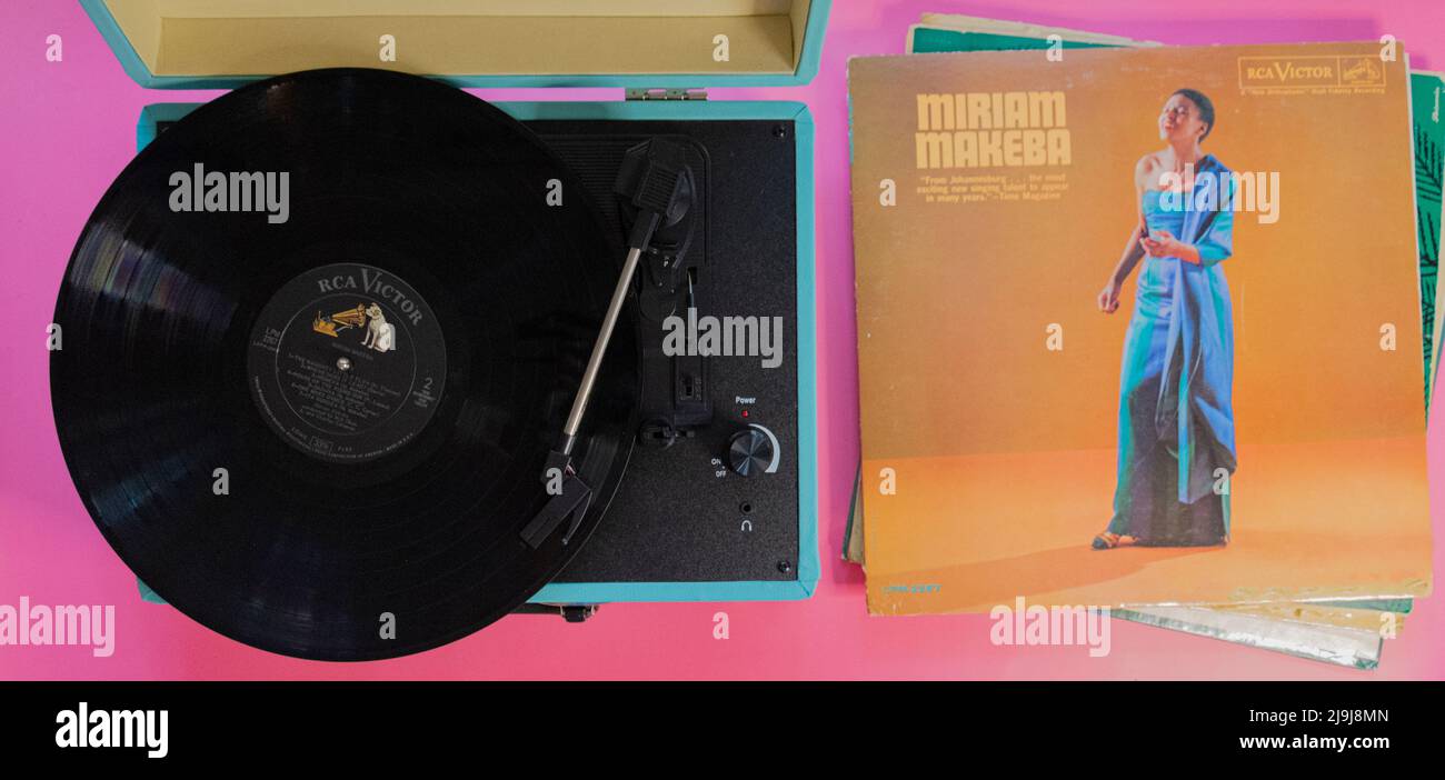 Teal record player with a pink background, the artist is Miriam Makeba Stock Photo