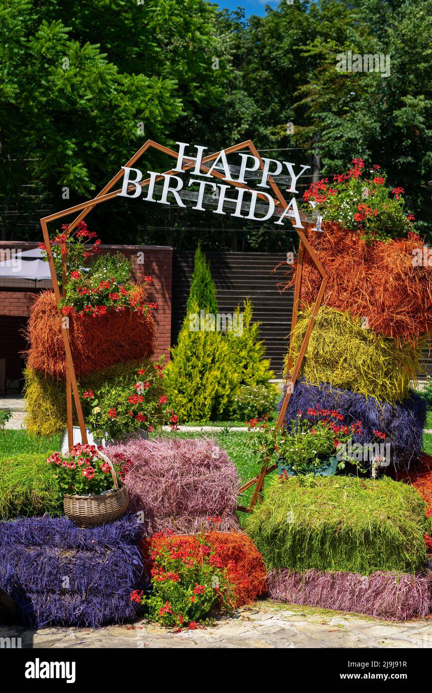Happy birthday photo area made of natural hay bales painted in different colors. Stock Photo