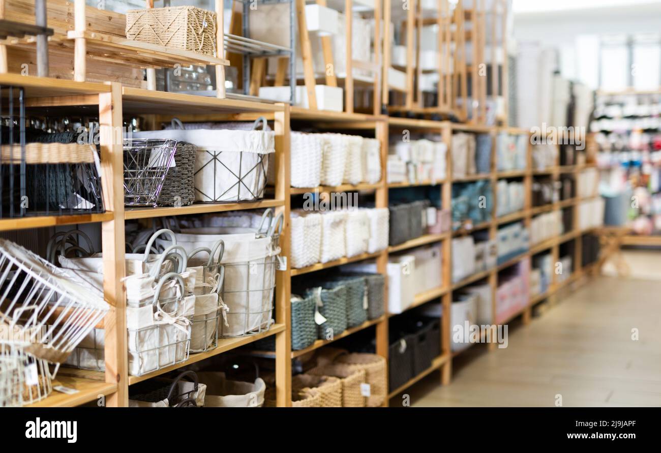 Decorative storage boxes on shelving in household goods store Stock