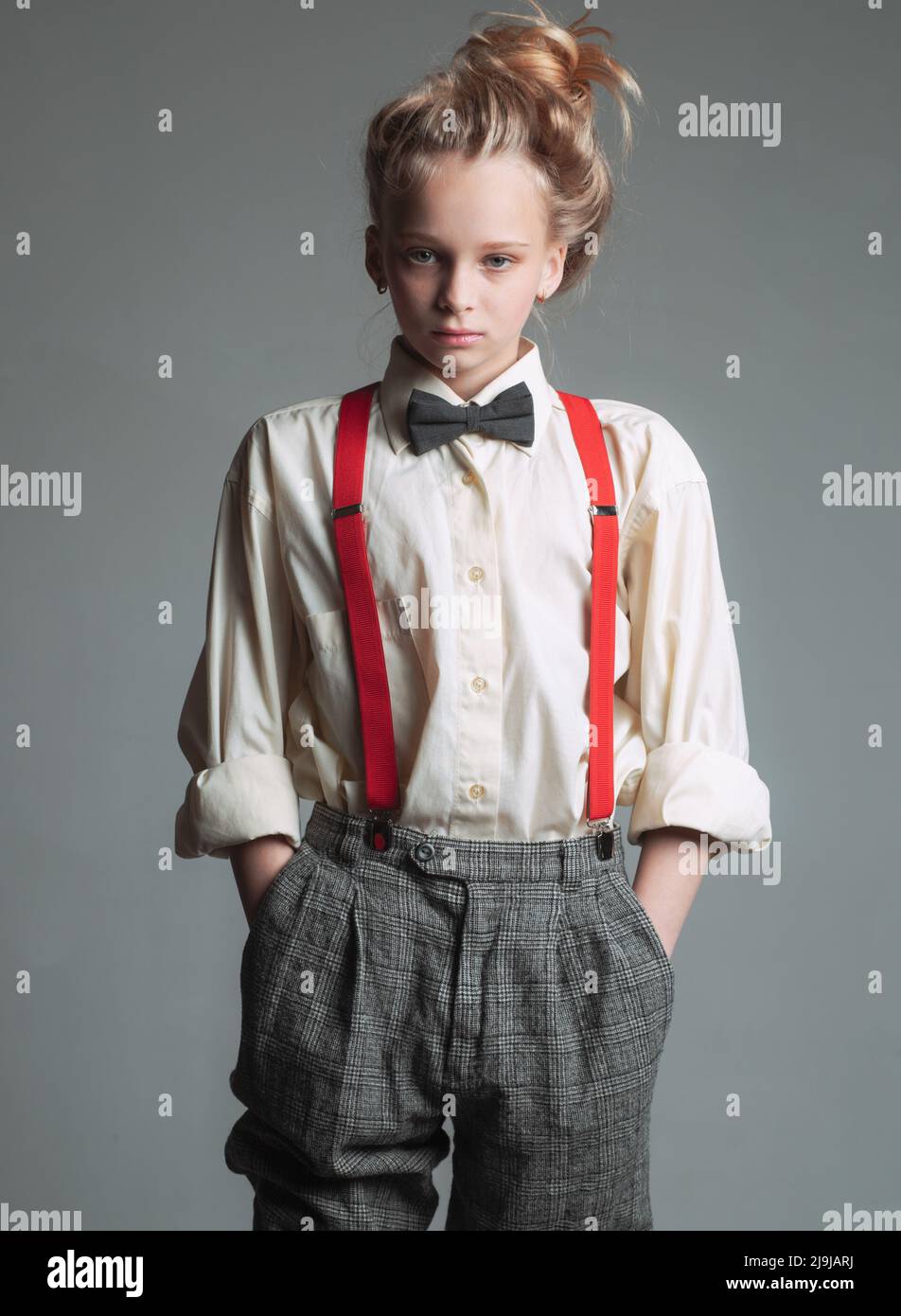 Funky style. suspender and bow tie. old fashioned child. vintage english style. retro fashion model. vintage charleston party. jazz step fashion. teen Stock Photo