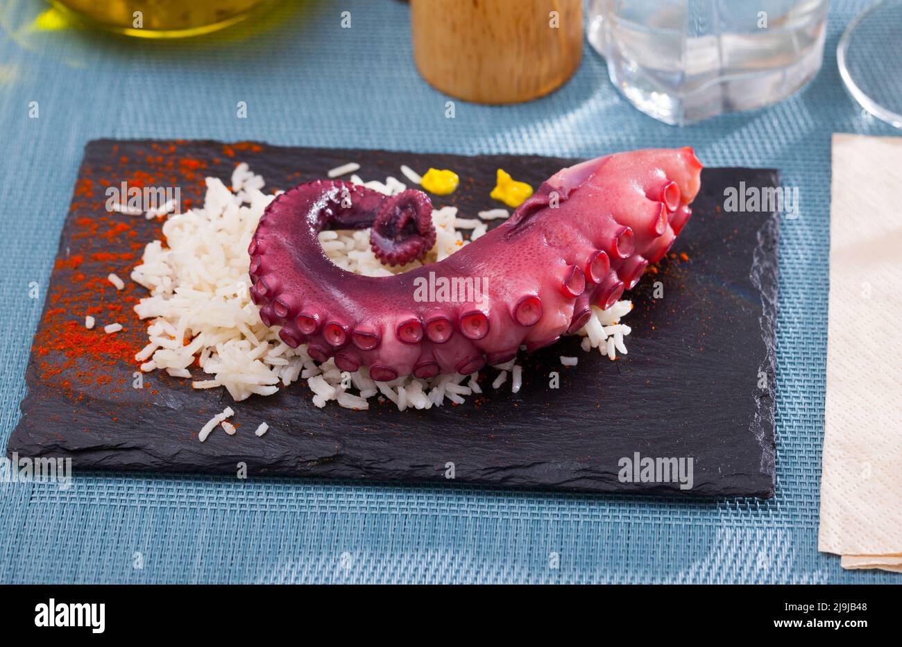 Slate of appetizing boiled octopus with rice Stock Photo - Alamy