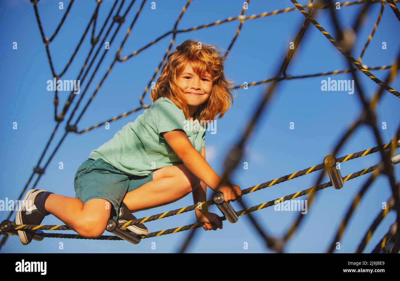 Happy Child Rope Happy child boy playing on the rope outdoor playground Stock Photo - Alamy