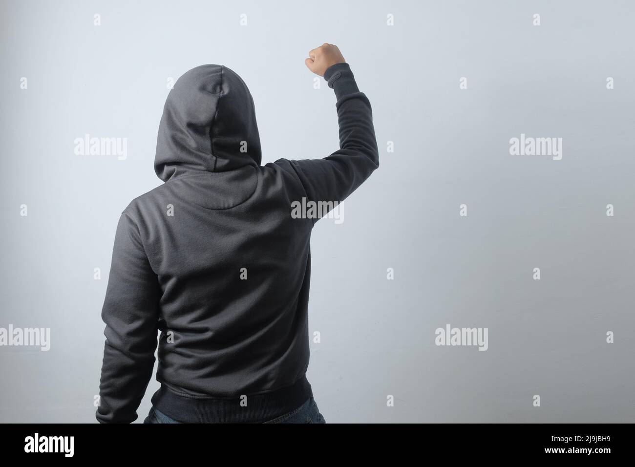 rear view mysterious man clenched fist, demonstration illustration