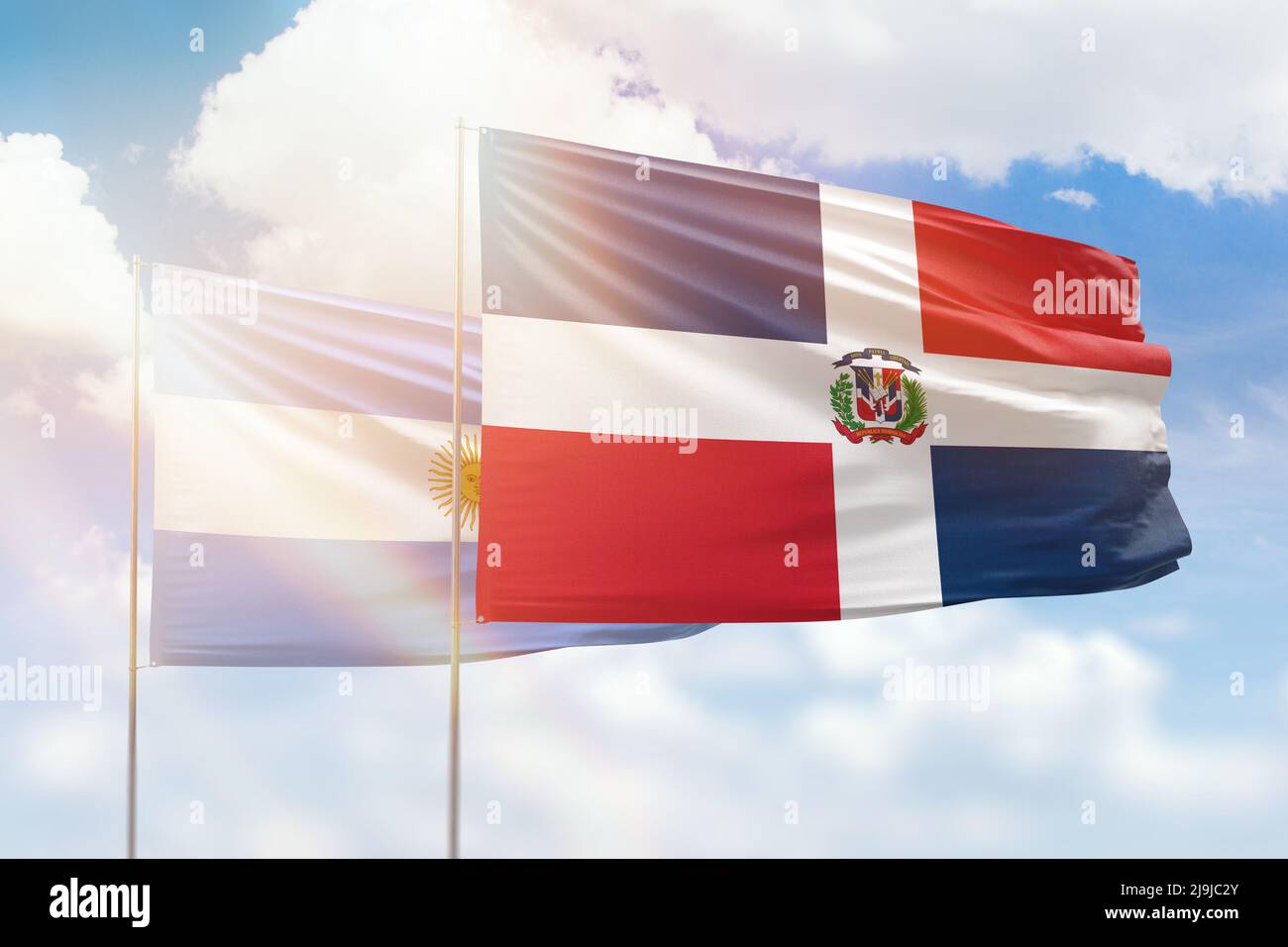 Sunny blue sky and flags of dominican republic and argentina Stock Photo