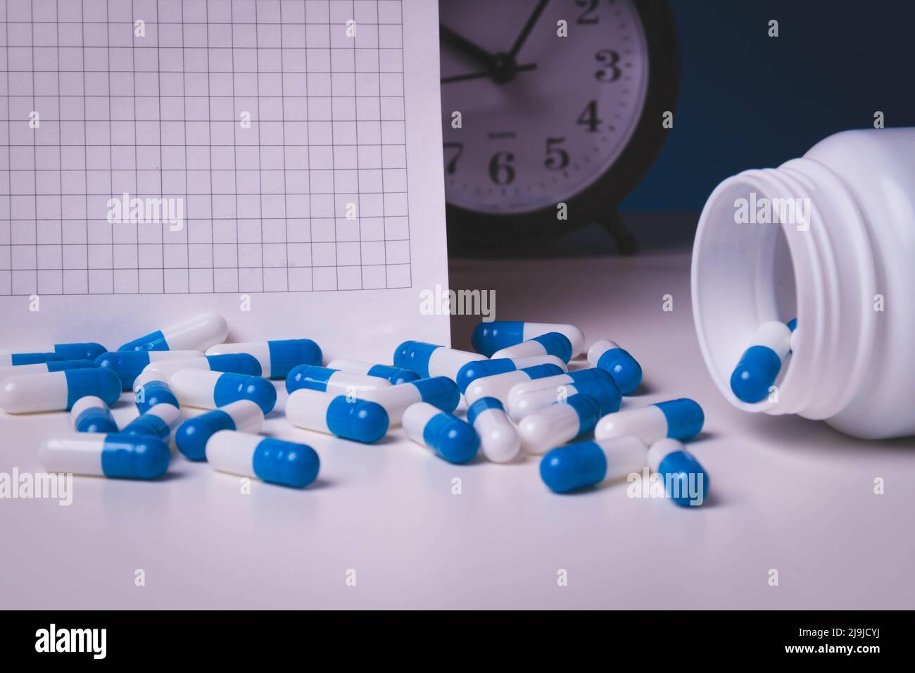 Time to take your medicine. Pill reminder. Tablets and alarm clock