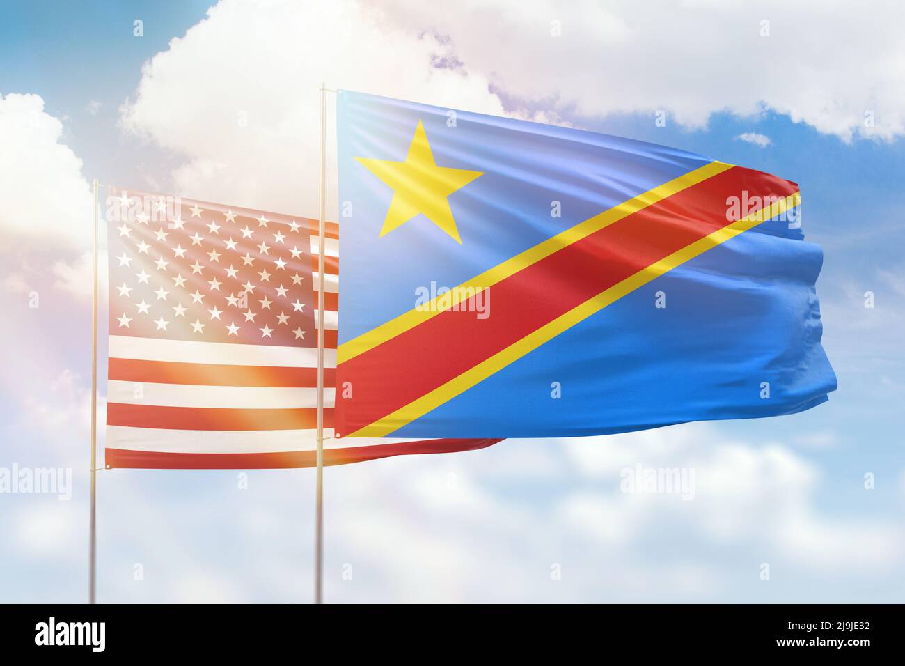 Sunny blue sky and flags of dr congo and usa Stock Photo