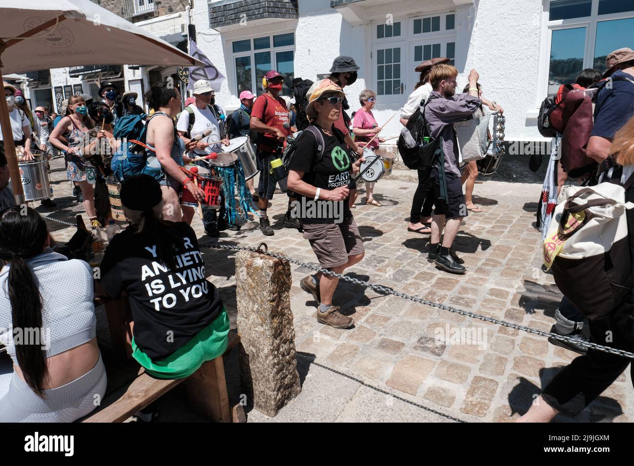 A samba band plays along the seafront in St Ives during the 'All Hands On Deck' day of action on the final day of the G7 summit in Cornwall. The theme is a reference to the Extinction Rebellion's third demand for a Citizens' Assembly on ecological and climate justice to move beyond broken parliamentary democracy and place power in the hands of citizens. Stock Photo