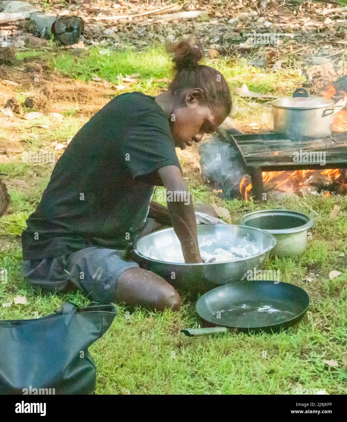 Young Aboriginal woman preparing food during cooking classes at the Taste of Kakadu Festival, Cooinda, Kakadu National Park, Northern Territory, NT, A Stock Photo
