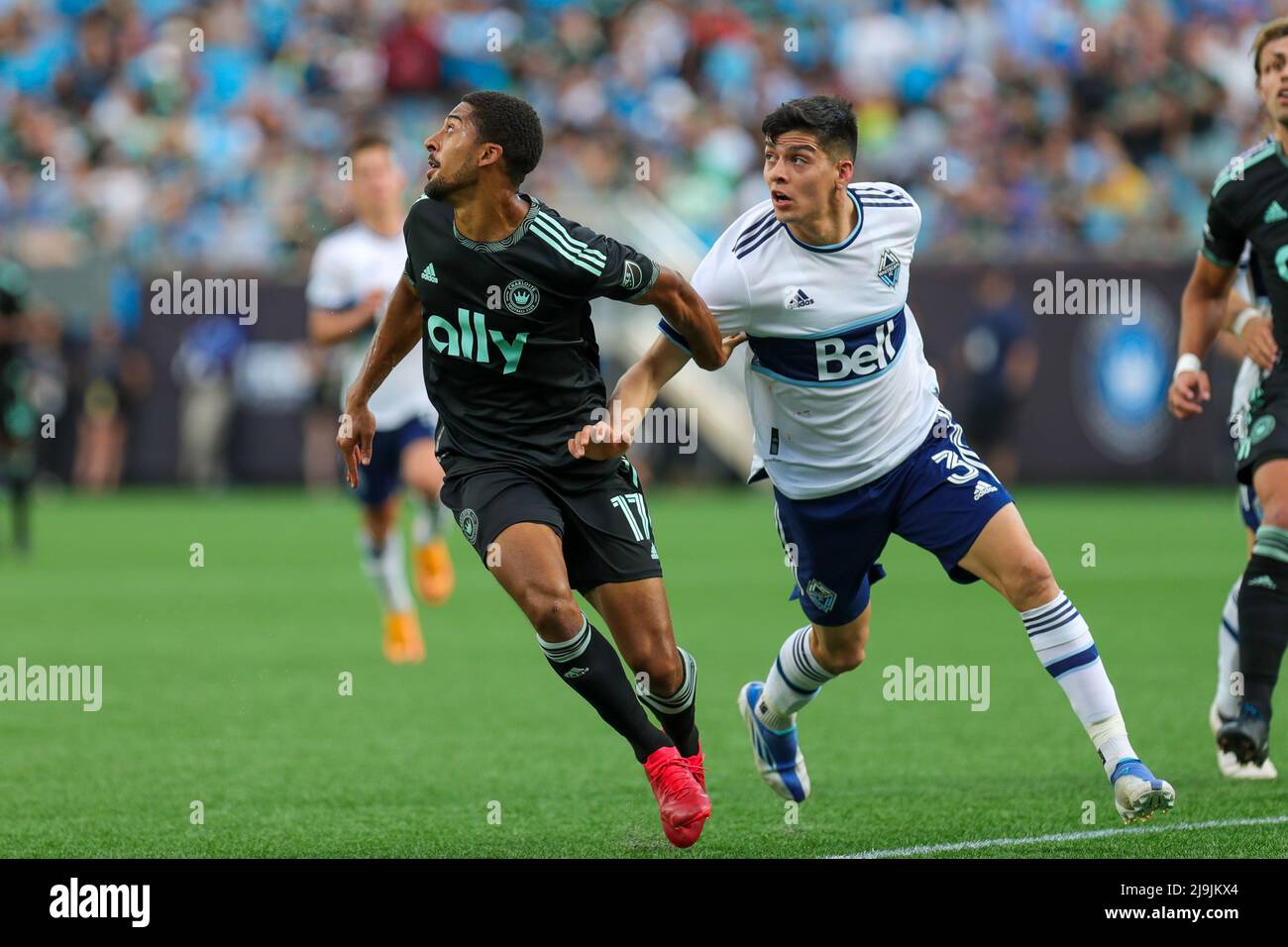 CHARLOTTE, NC - MAY 22: McKinze Gaines (17) of Charlotte FC and CristiÃ¡n GutiÃ©rrez (3) of Vancouver Whitecaps chase down a high kicked ball during a soccer match between the Charlotte FC and the Vancouver Whitecaps on May 22, 2022 at Bank of America Stadium in Charlotte, NC. (Credit Image: © David Jensen/Icon SMI via ZUMA Press) Stock Photo