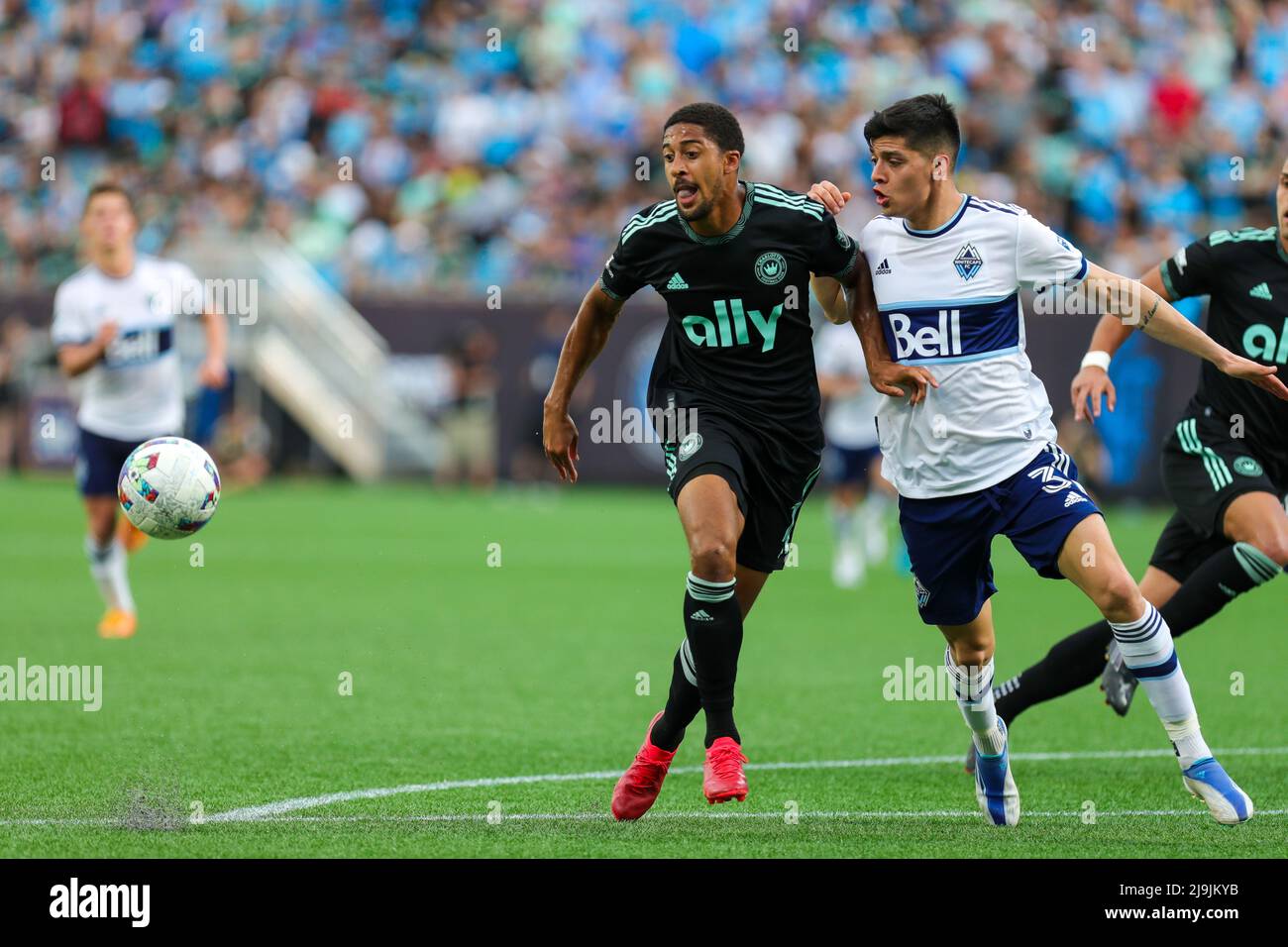 CHARLOTTE, NC - MAY 22: McKinze Gaines (17) of Charlotte FC and CristiÃ¡n GutiÃ©rrez (3) of Vancouver Whitecaps chase down a loose ball during a soccer match between the Charlotte FC and the Vancouver Whitecaps on May 22, 2022 at Bank of America Stadium in Charlotte, NC. (Credit Image: © David Jensen/Icon SMI via ZUMA Press) Stock Photo