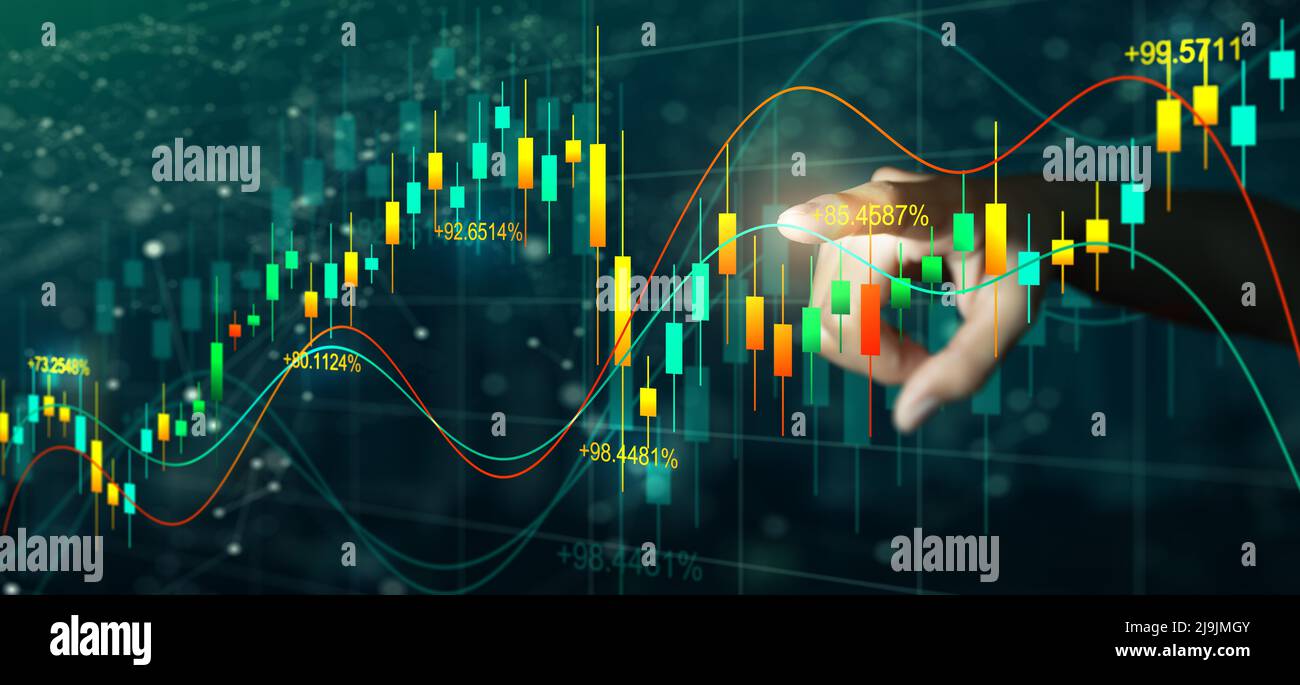 Double exposure of Business man hand on digital stock market financial indicator with night city background. Abstract financial trading graphs. Stock Photo