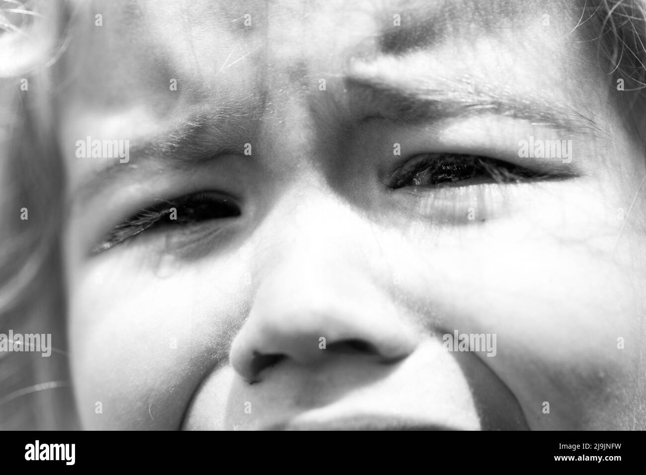 Small cute girl is crying. Sad child. Stock Photo