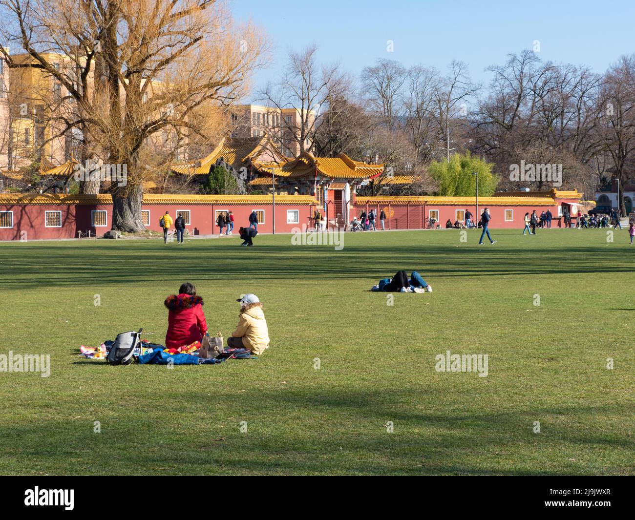 Zurich, Switzerland - March 5th 2022: People relaxing in a park close to China garden. Stock Photo