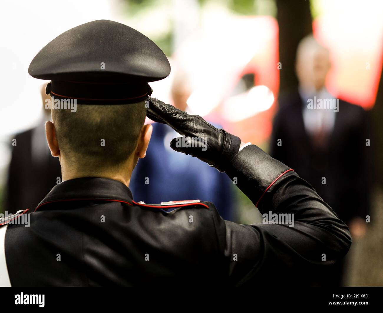 Shallow depth of field (selective focus) details with an Italian policeman in a ceremonial uniform saluting. Stock Photo