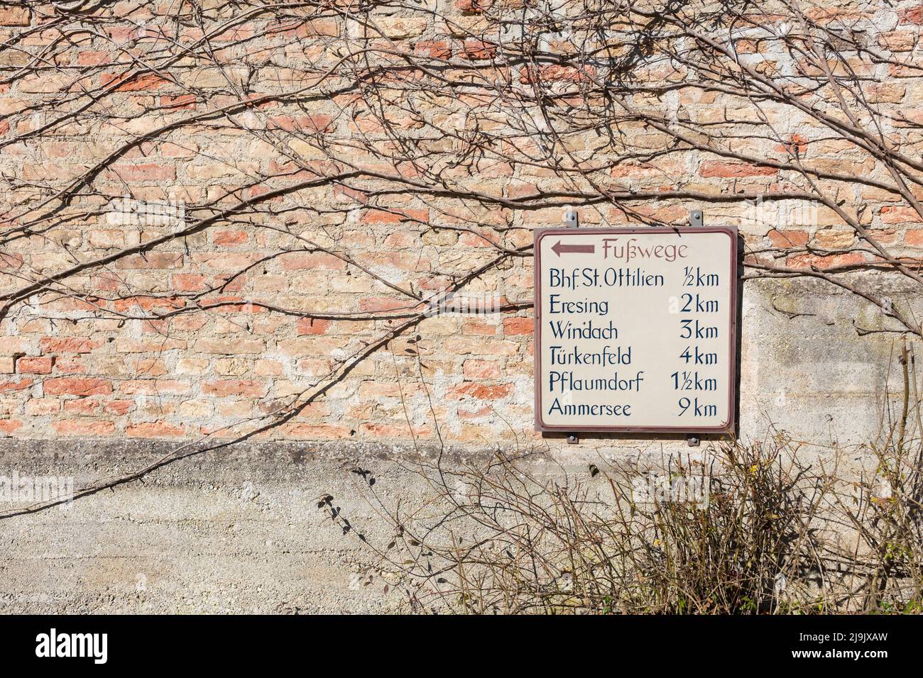 St. Ottilien, Germany - Mar 13, 2022: Sign indicating the distance of several hiking destinations in the vicinity of the Landsberg am Lech district. S Stock Photo