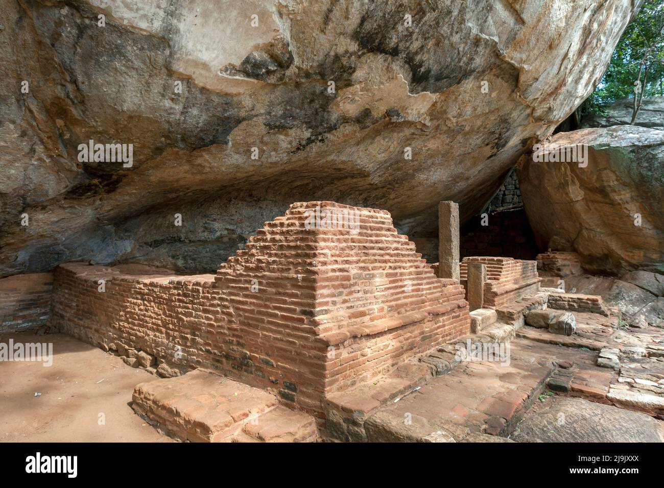The ruins of the Image Cave at the base of Sigiriya Rock Fortress at Sigiriya in Sri Lanka. It was originally a dwelling for the Sangha. Stock Photo