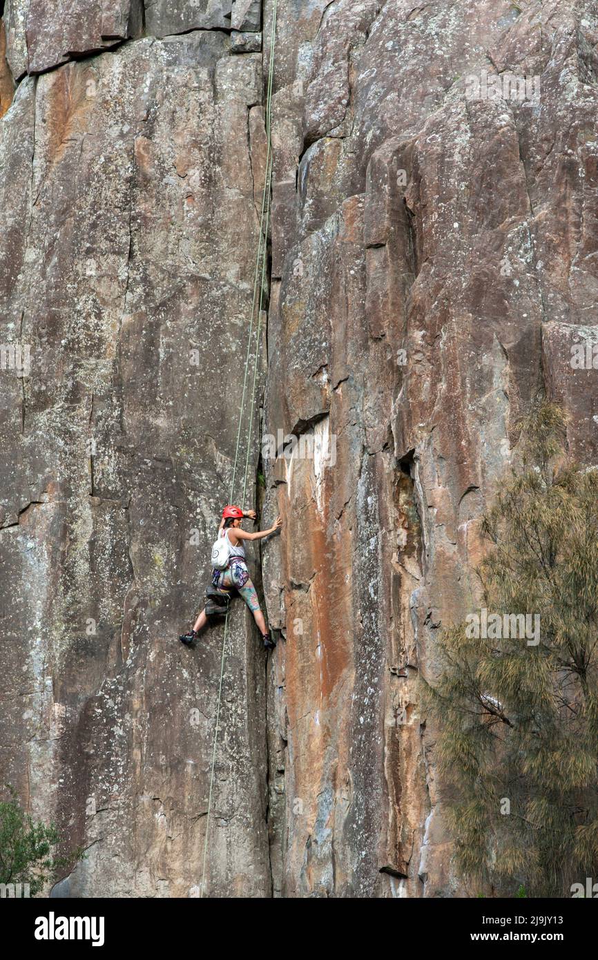 A rock climber ascends a granite cliff face on the lower section of the Cataract Gorge at Launceston Stock Photo