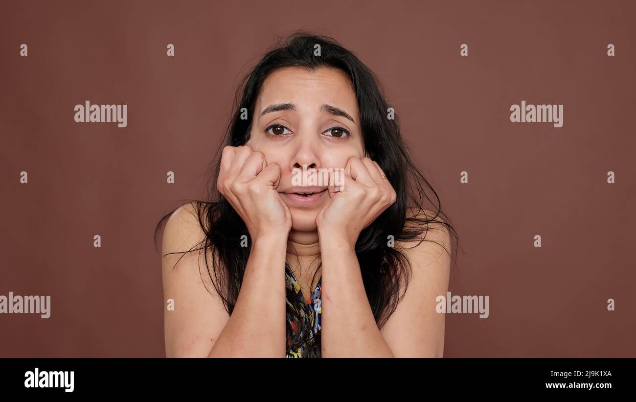 Portrait of shocked terrified adult showing fear and panic in front of